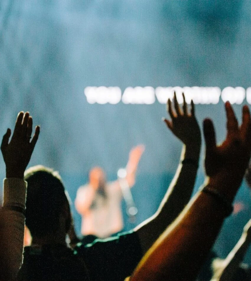 Hands raised in worship during a service