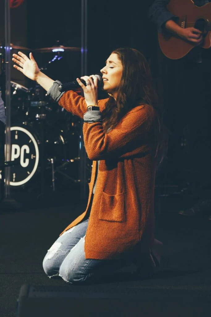 A singer leading worship on stage