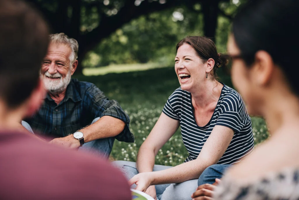 Adults talking together outdoors at the West campus